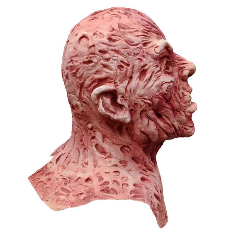 Halloween horror latex mask — hollow eyes and weathered skull sculpt, eerie lighting