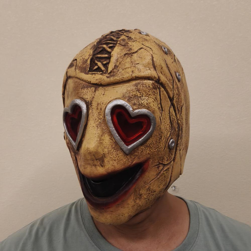Heart Eye Zombie Mask front view — cracked latex face with red heart-shaped eye cutouts